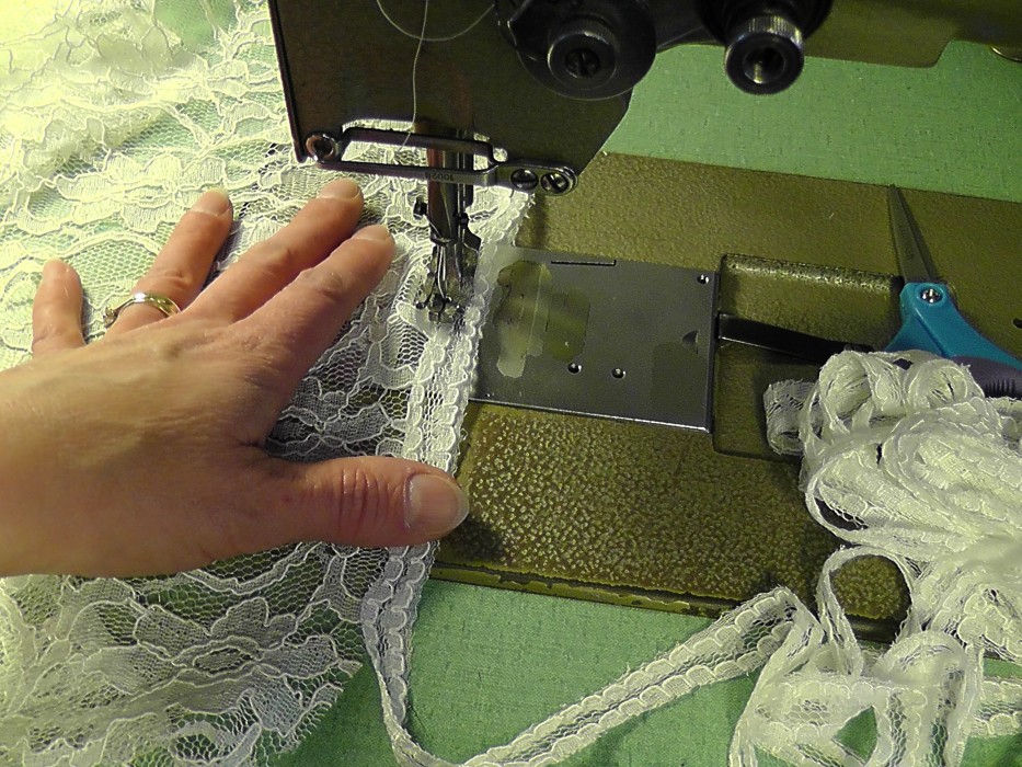 Applying lace to hem.