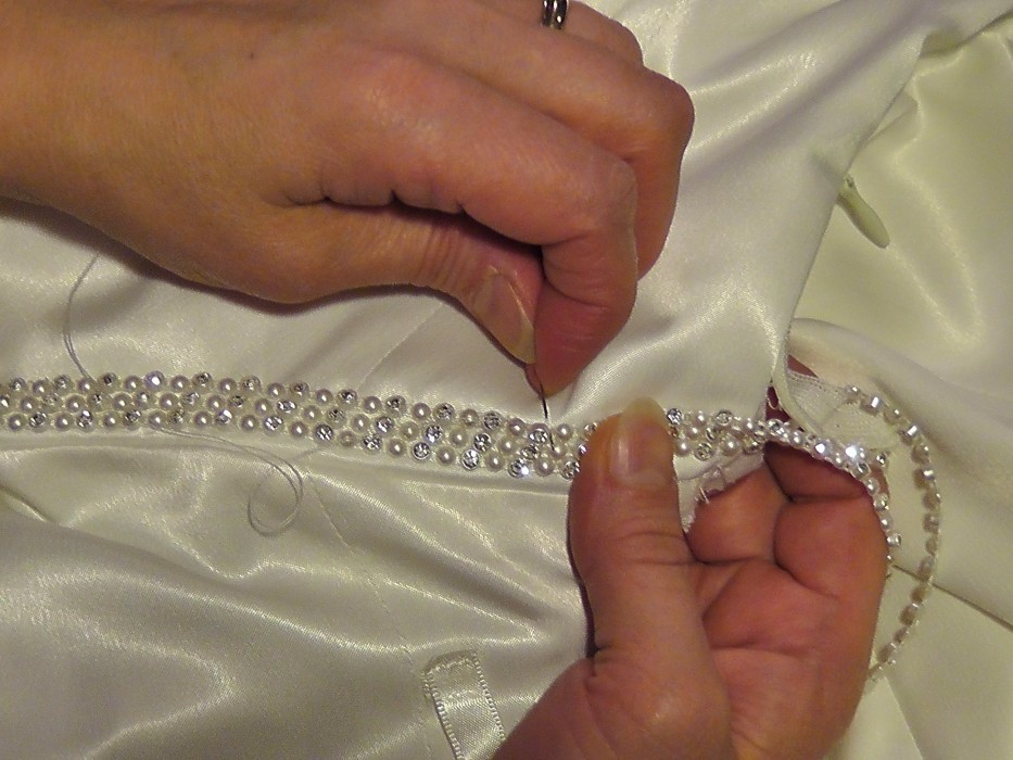 Hand sewing embellishments.