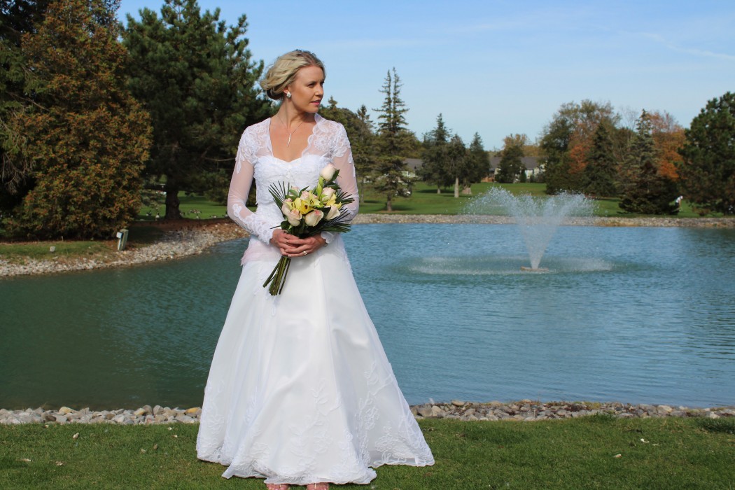 Applique tulle on tulle overlay of satin strapless a-line wedding dress with bolero jacket.